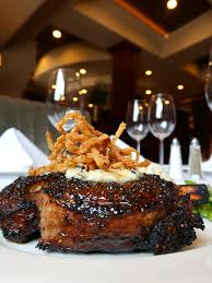 Churchill's Steakhouse signature dishes 28-Day Dry-Aged USDA Prime Steaks, Filet Mignon, Lobster Tail, Churchill's Potatoes